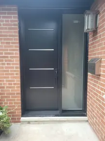 Front-steel-Vog-door-with-steel-accents-and-sidelite.JPG