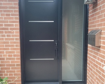 Front-steel-Vog-door-with-steel-accents-and-sidelite.JPG