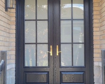 8' high black fiberglass door with 22x64- frosted glass with SDL grills.jpg