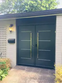 Black Double door, contemporary steel Vog with accents and pull bar handles.jpeg