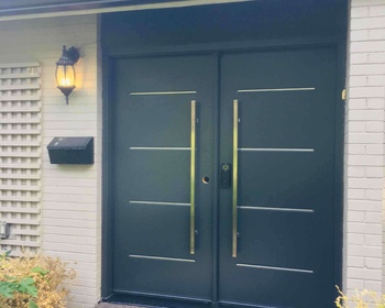 Black Double door, contemporary steel Vog with accents and pull bar handles.jpeg