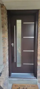 Brown Modern Steel door with 7x64- Oso glass and Steel line accents with pull bar handle.jpg