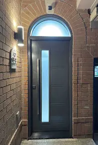 Contemporary steel grey entry door with 7x64- frosted glass, arched transom and squared pull bar han