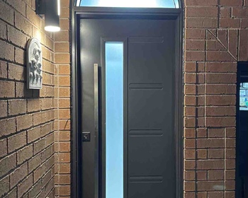Contemporary steel grey entry door with 7x64- frosted glass, arched transom and squared pull bar han