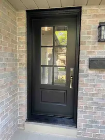 Steel entry black door with 22x48- clear glass and 2x3 flat SDL grills.jpg