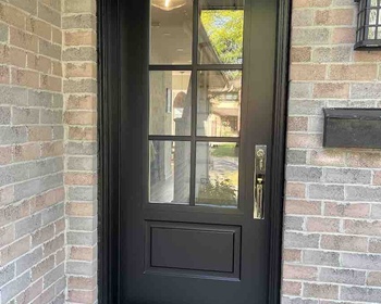 Steel entry black door with 22x48- clear glass and 2x3 flat SDL grills.jpg