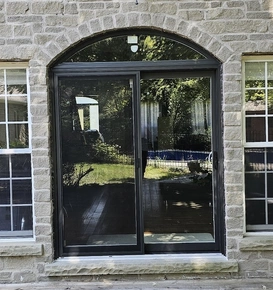 Black sliding door with curved transom.jpg