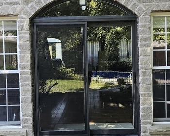 Black sliding door with curved transom.jpg