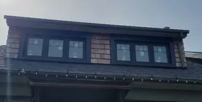 Black casement windows with large aluminum capping and grills in Etobicoke.jpg