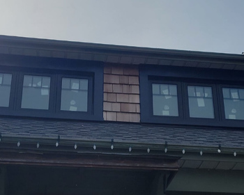 Black casement windows with large aluminum capping and grills in Etobicoke.jpg