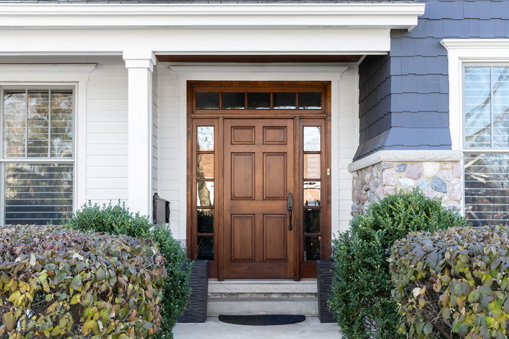 Wooden front door on an Ontario home exterior used to illustrate front door cost in 2026 and curb appeal upgrades.