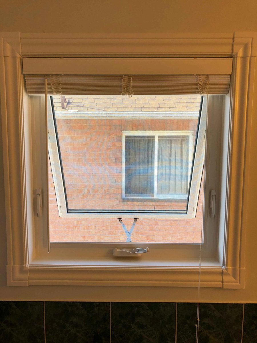 Awning bathroom window installed high on wall for privacy and airflow