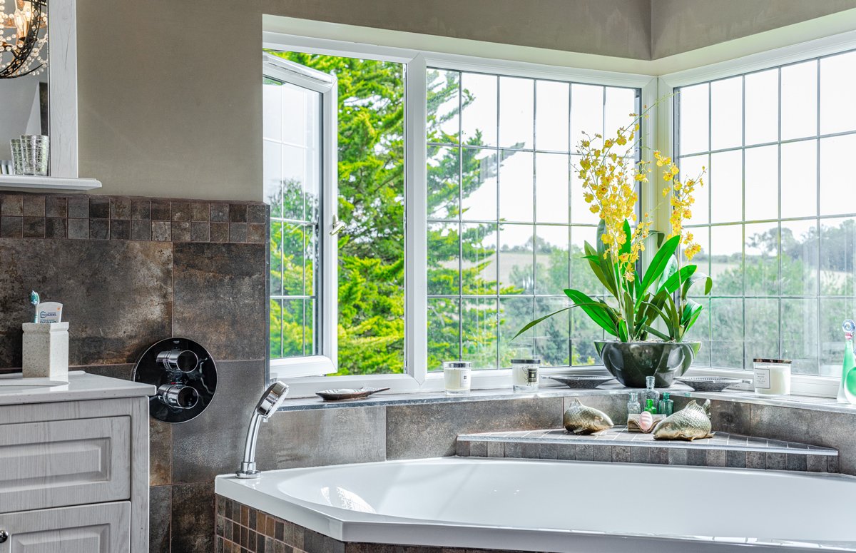 Casement bathroom window open for ventilation in modern home bathroom