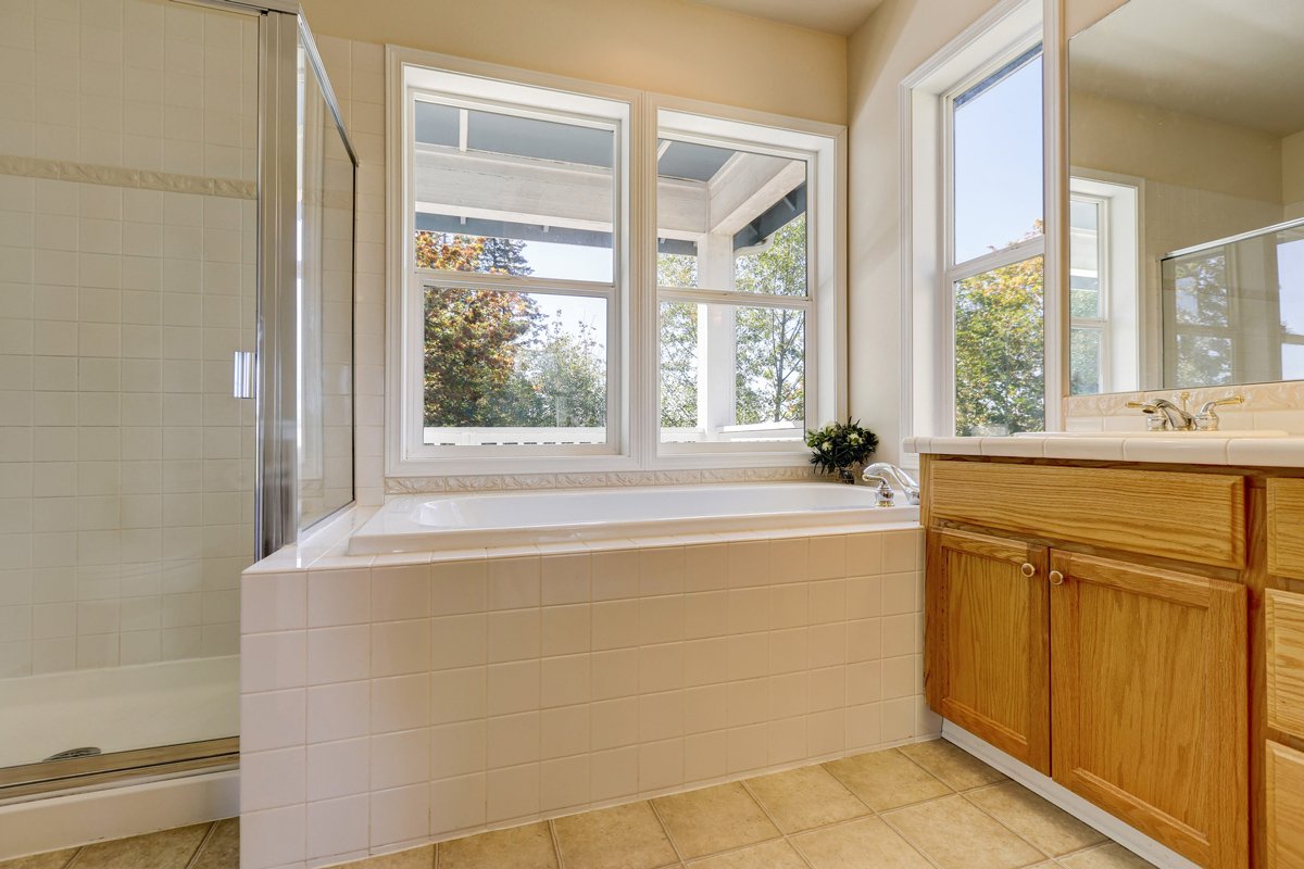 Double hung bathroom window with top and bottom ventilation in traditional interior