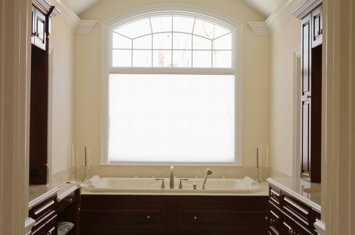 Transom bathroom window above opening adding light and privacy