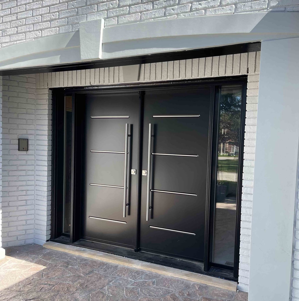 Modern steel front door installed in a Canadian home – durable, energy-efficient, and stylish.