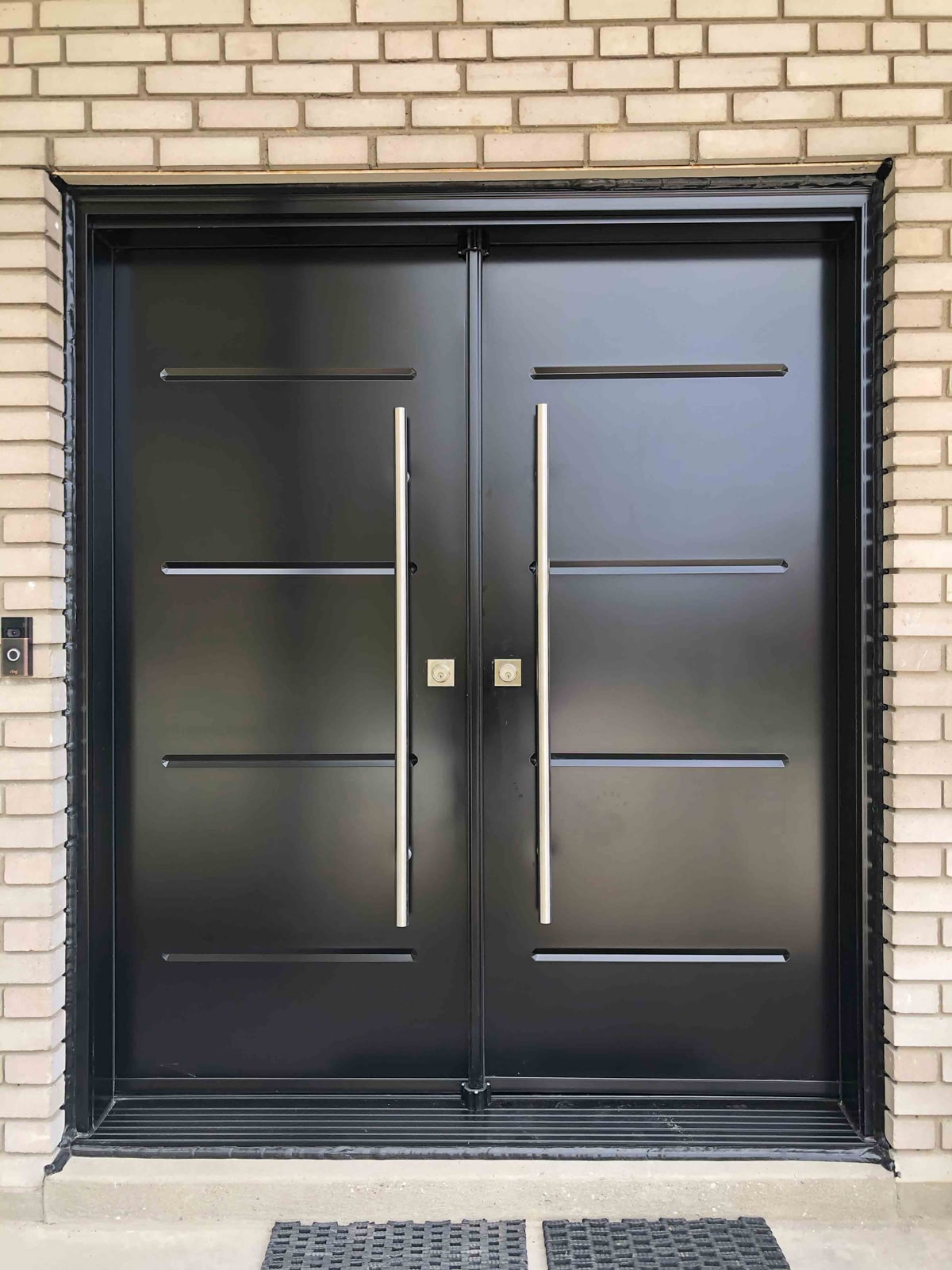 Steel entry door paired with modern black-framed windows for a contemporary home exterior.